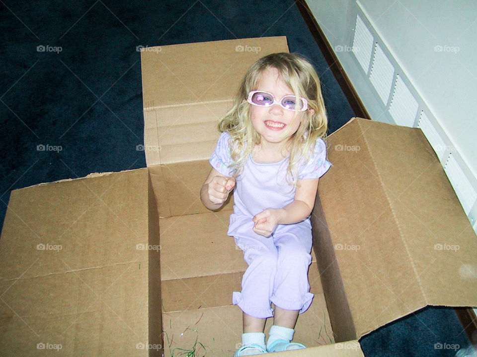 Great Big Imagination- flying a cardboard box plane.  Notice the upside down sunglasses?