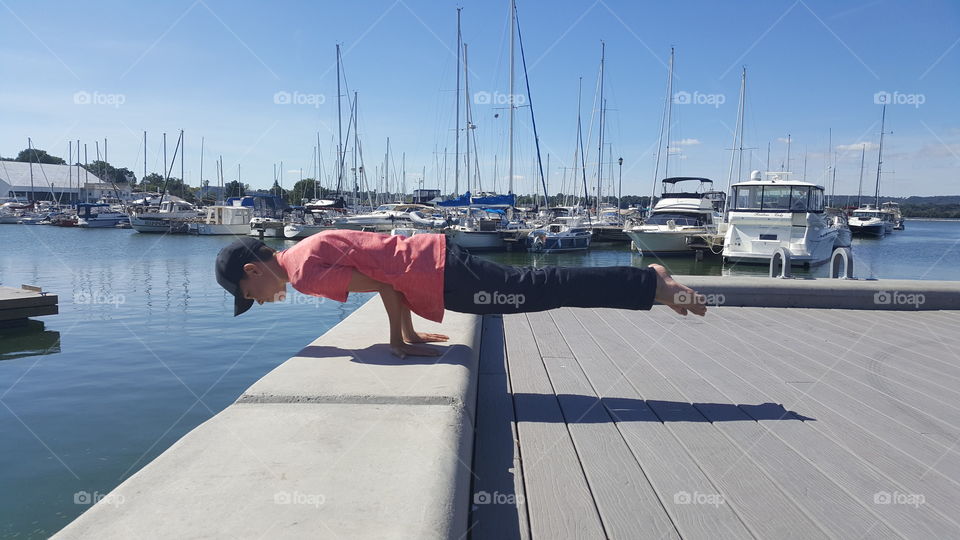 boy planking in marina