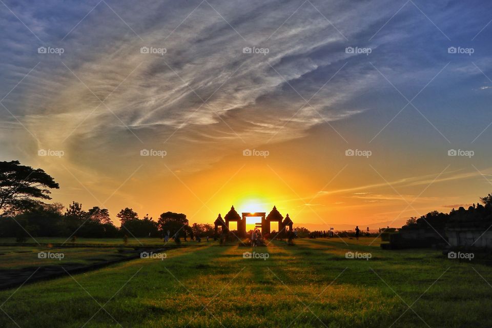 People enjoying the sunset scenery on ratu boko archaelogical site. This photo has been edited from original one that previously been uploaded to foap.