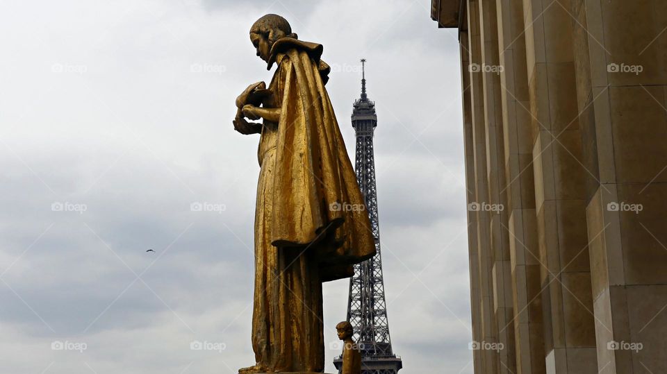 From the Ground Up - Early morning view of the Eiffel Tower and gold statues. The Trocadéro site of the Palais de Chaillot, is an area of Paris, France, in the 16th arrondissement, across the Seine from the Eiffel Tower.