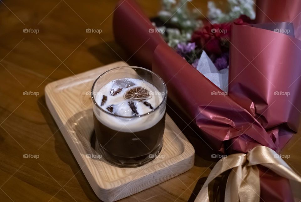 cold brew coffee and a bucket of flowers