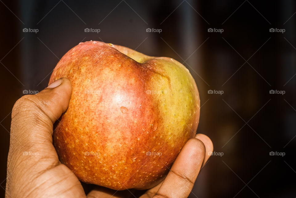 Close-up of person hand's holding apple