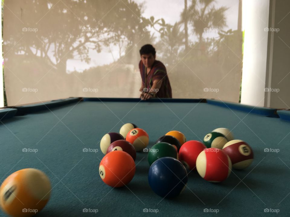 Man playing billiards pool in the tropics