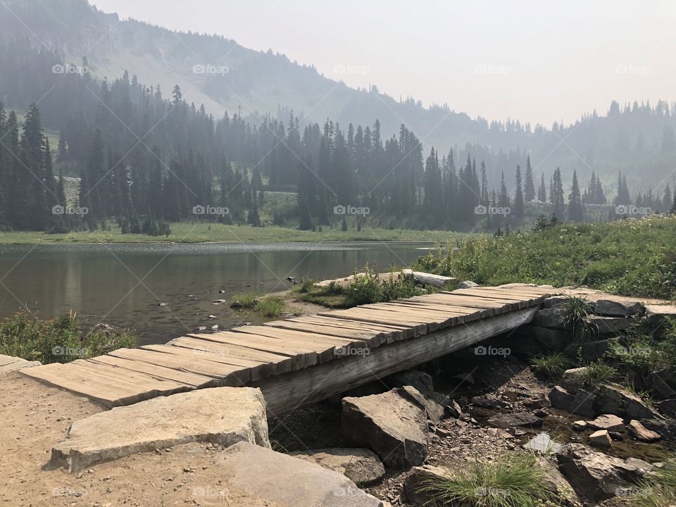 Wooden bridge crossing a stream in the mountains