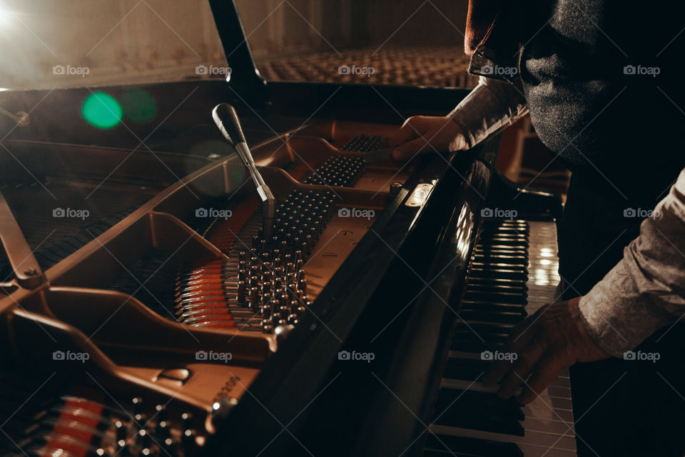 the piano tuner works with the instrument