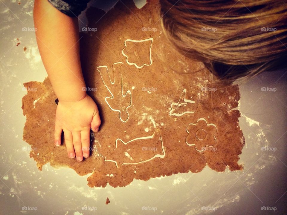 Kid baking gingerbread cookies from above 