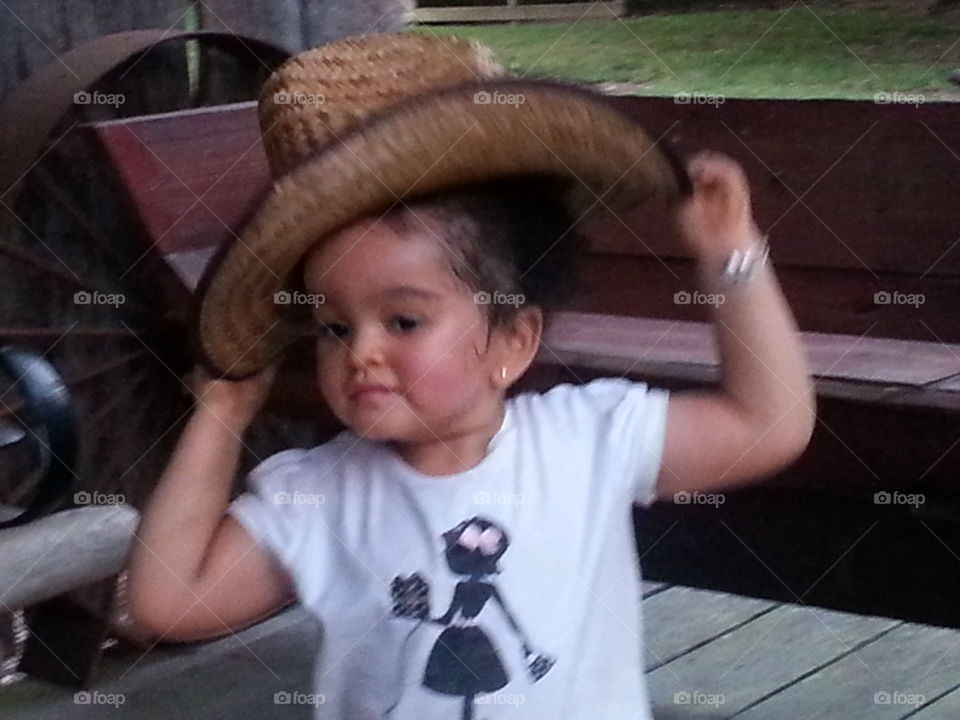 Whose Hat?. No idea whose hat she picked up and tried on