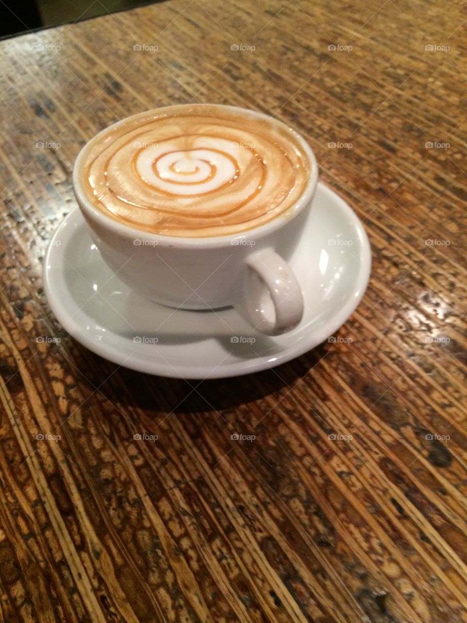 Heart latte art with caramel swirl