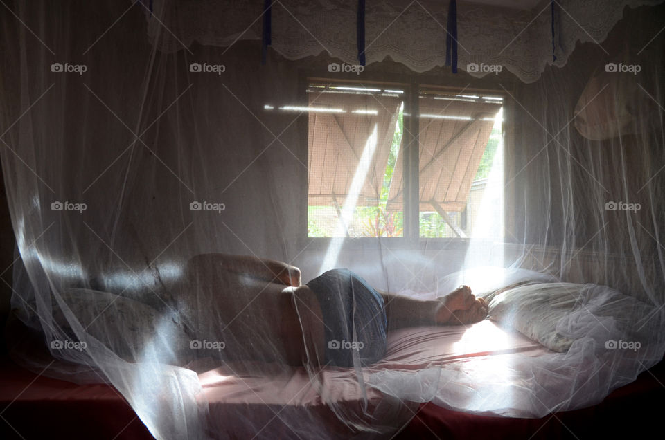 Sleeping under the mosquito net