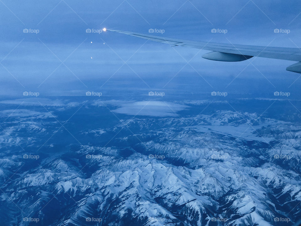 The magical view of ice mountains through airplane window-seat