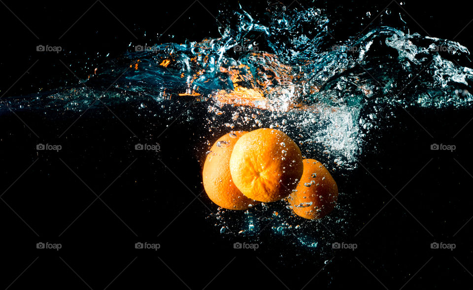 orange in black water
