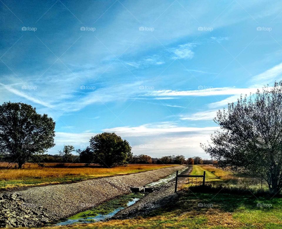 Stunning fall colored scene. Water run off is moss licked "Call Me Home". Beautiful blue skies.