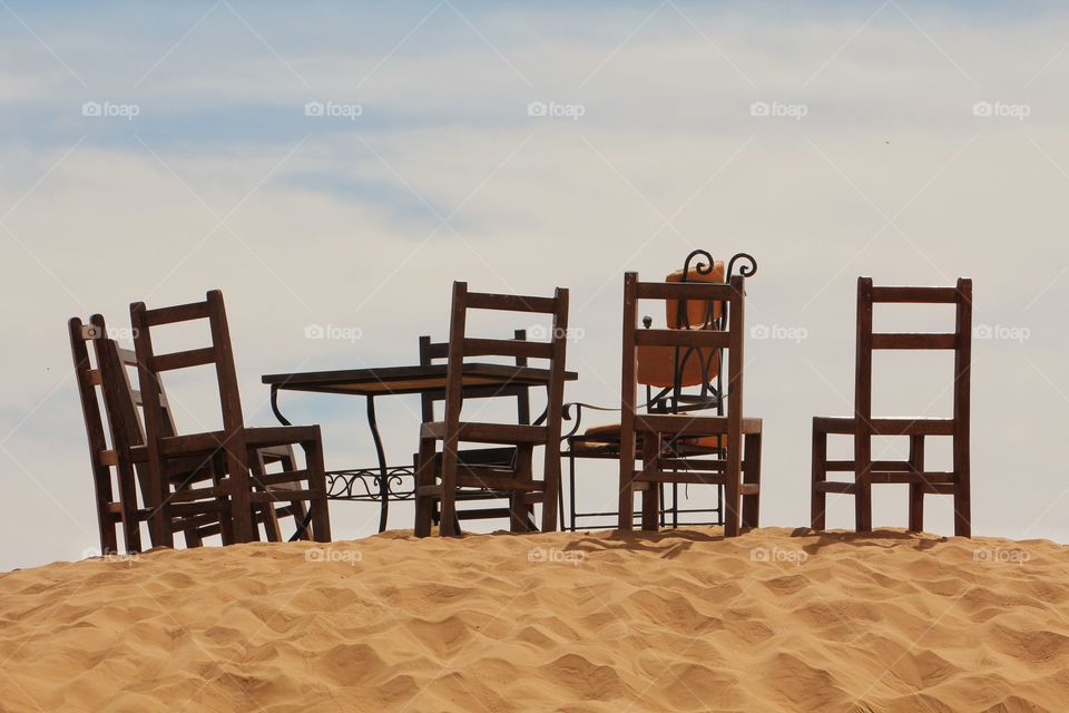 Table and chairs in the sand dunes of the Sahara 