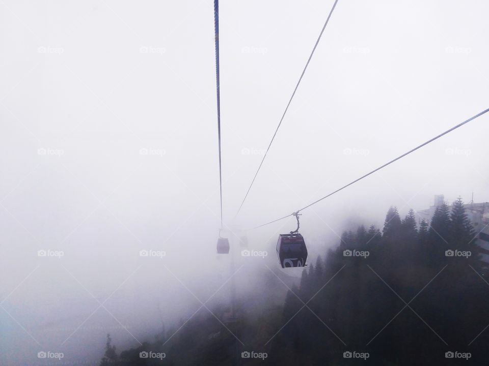 A ride of cable car in the heavy fog.