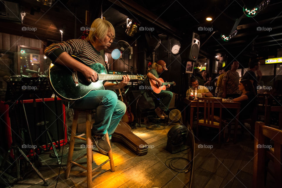 Musician playing guitar in the club 