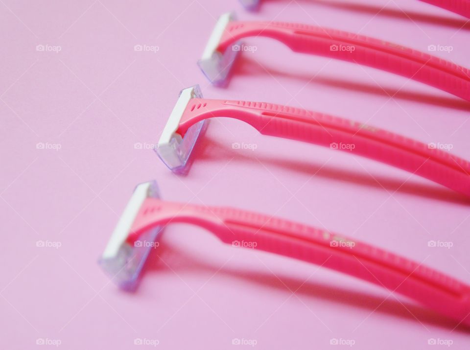 Pink razors on pink background