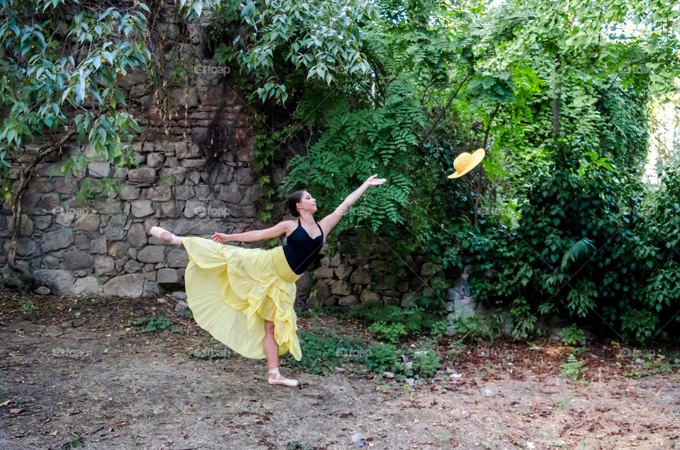 Young Female Ballerina Dancing Outside in Nature