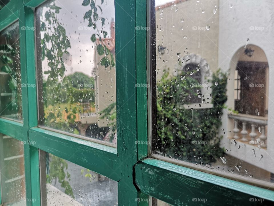 Vintage window with rain drop on glass.