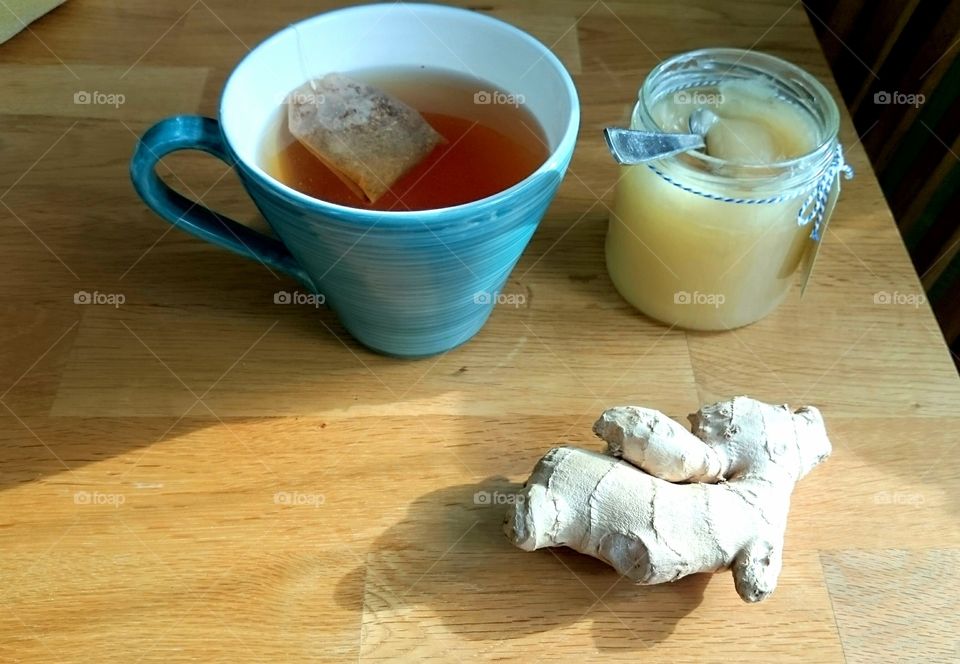 a cup of tea with honey and fresh ginger