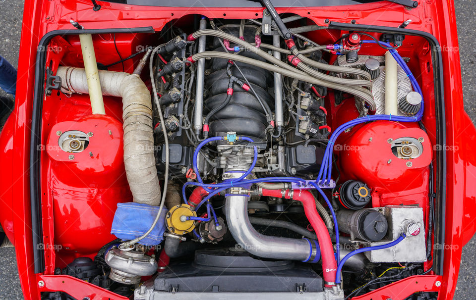 top view of new modern powerful hi-tech racing car engine with red body