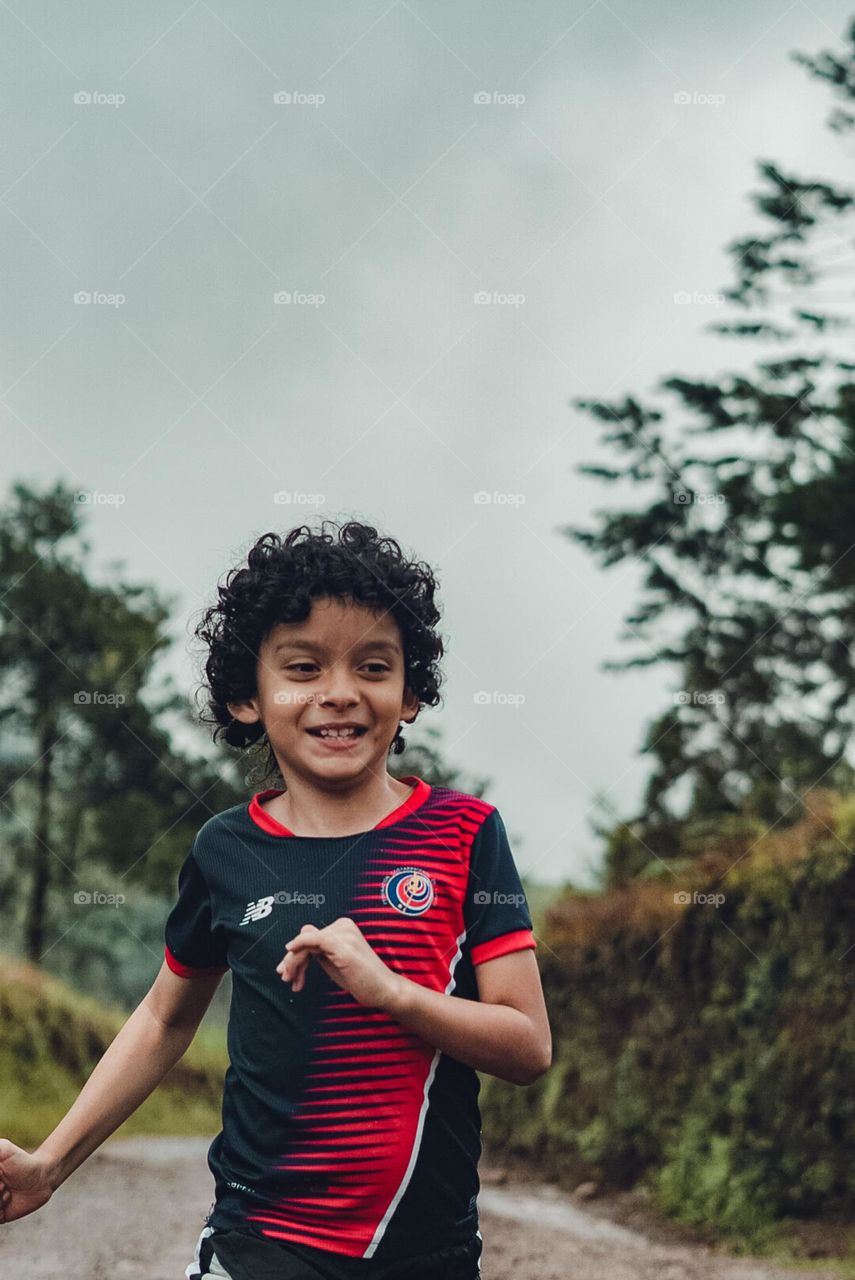 Happy child enjoying running in nature