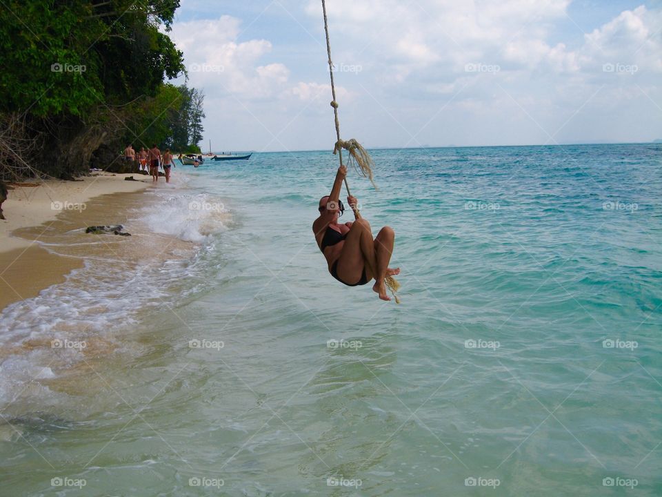 Swinging on a rope. Koh Poda