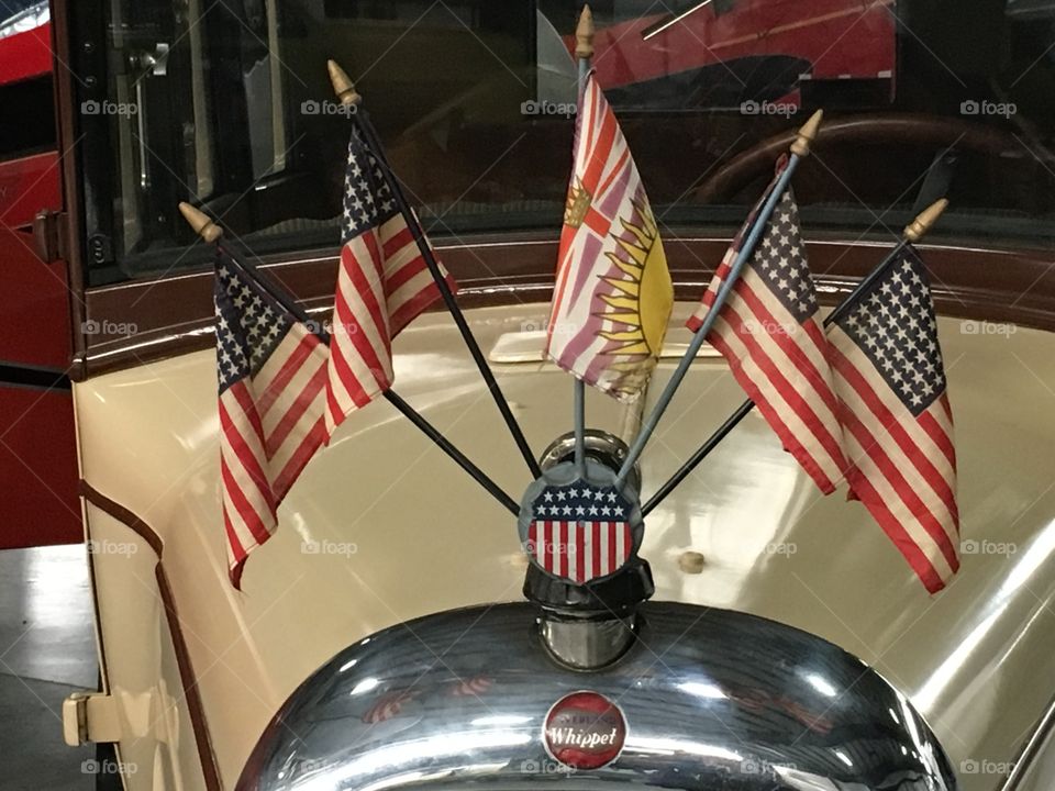 Flags on antique auto