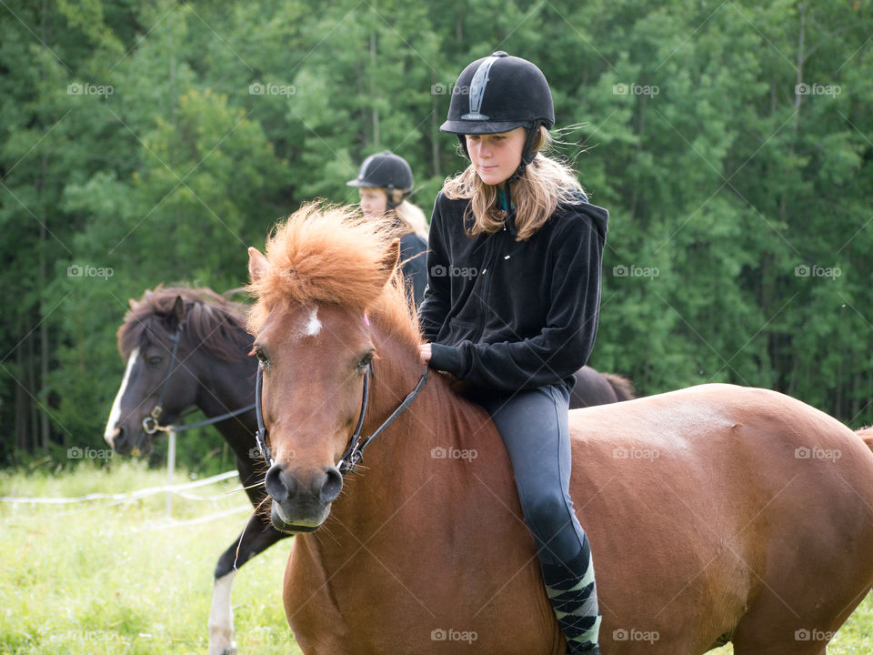 Teenage girl riding horse