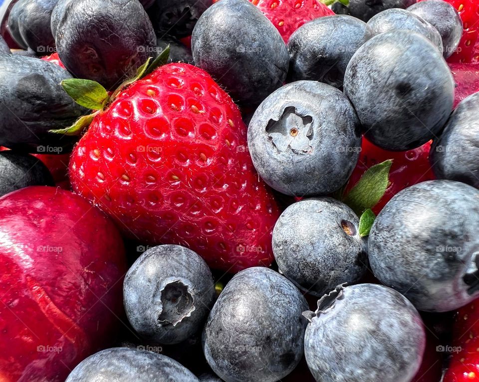 Summer season ripe blueberries, strawberries and cherries 