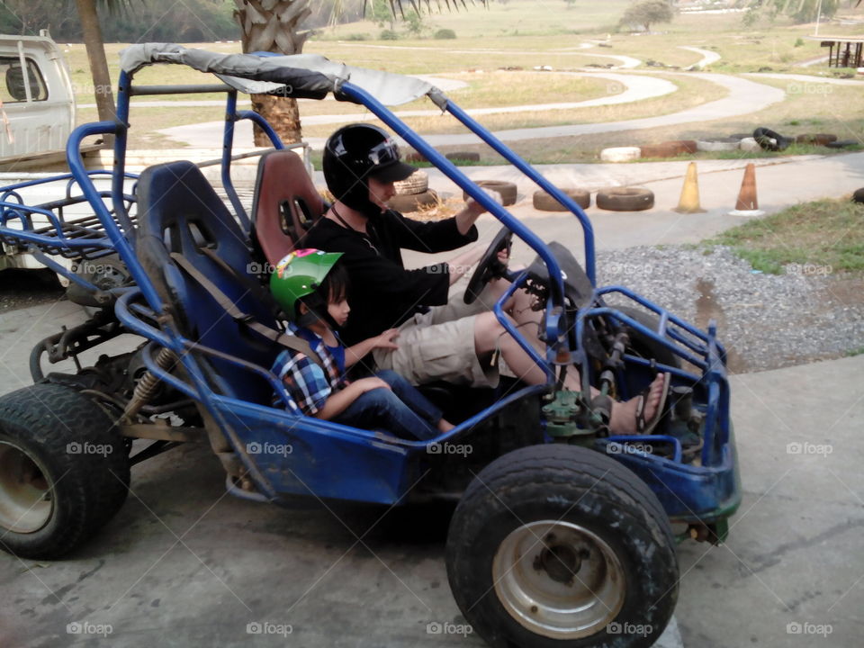 father and son driving a buggy . great family fun 