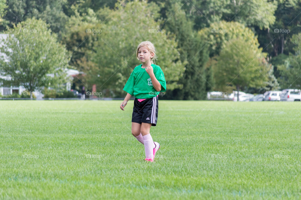 Girl walking on grass in park