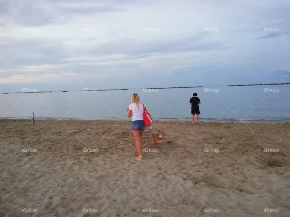 woman on the beach with a dog