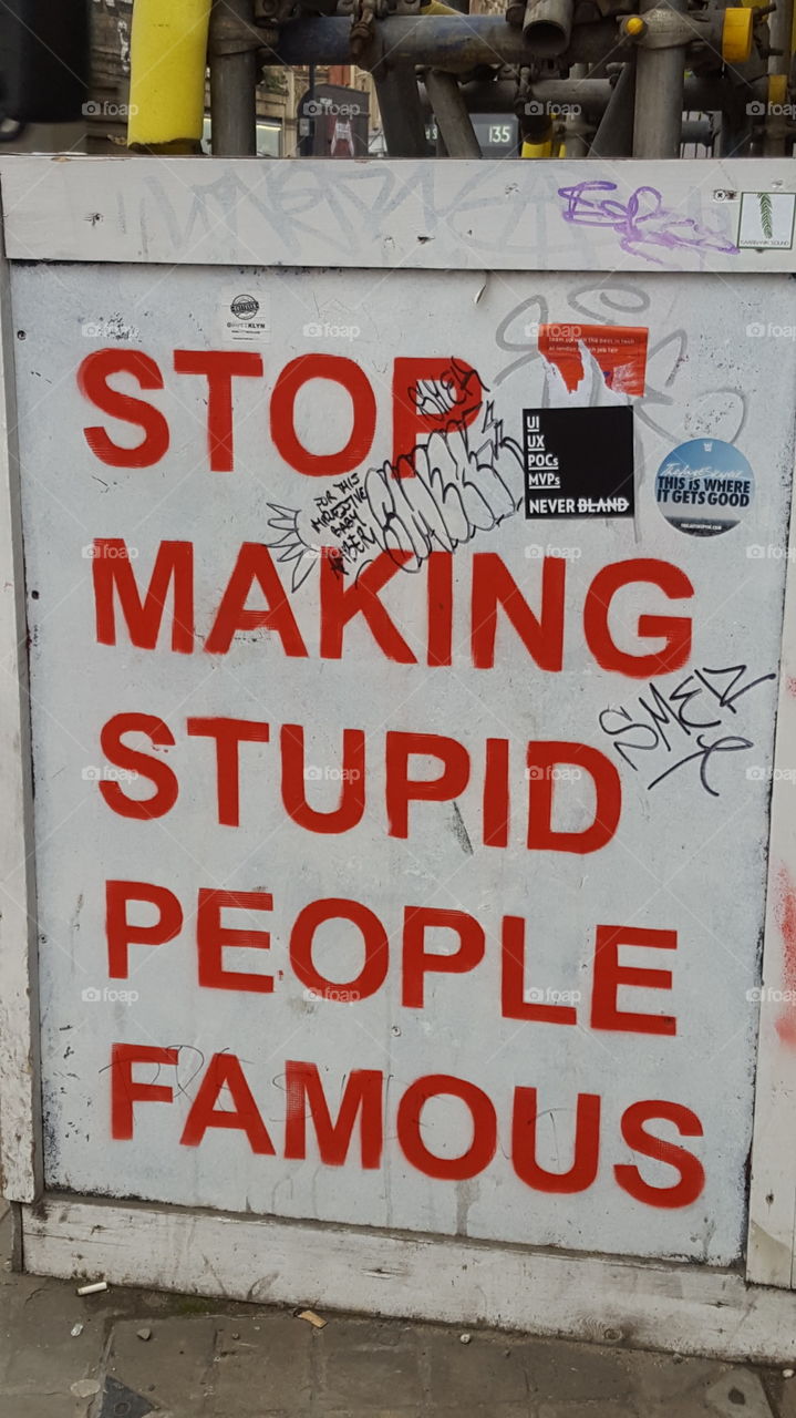 stop making stupid people famous sign