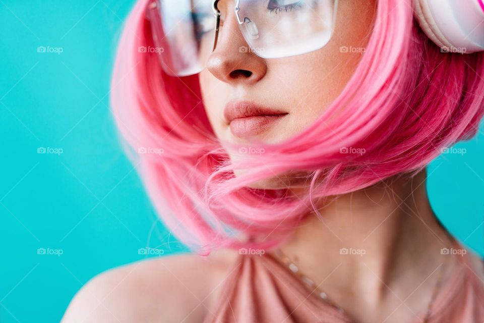 A teenager with pink hair.  Beautiful face of a girl close-up