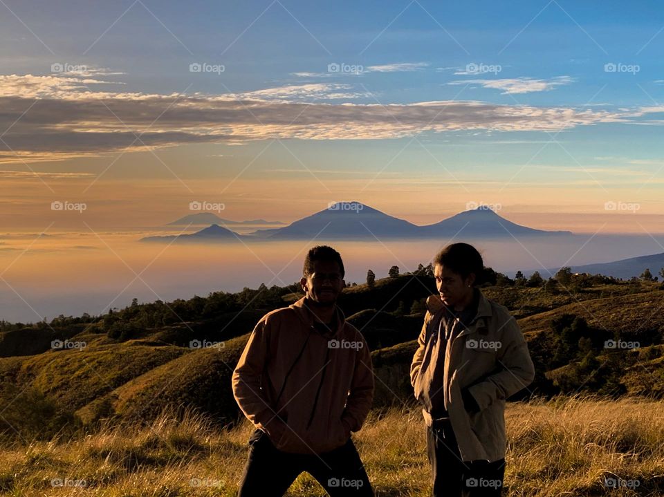 Two hikers at the top of the mountain.