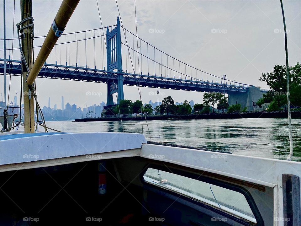 We are making headway motoring our new boat down the “East River” towards “Newtown Creek” by the “Pulaski Bridge”. The long structure is the “Throggs Neck Bridge”. 2023. Hypnotic Productions