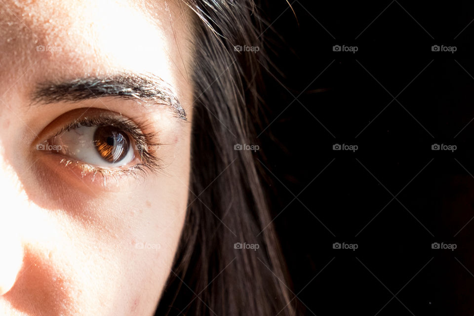 A young woman in bright sun rays