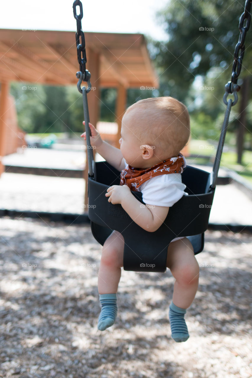 Baby sitting in swing