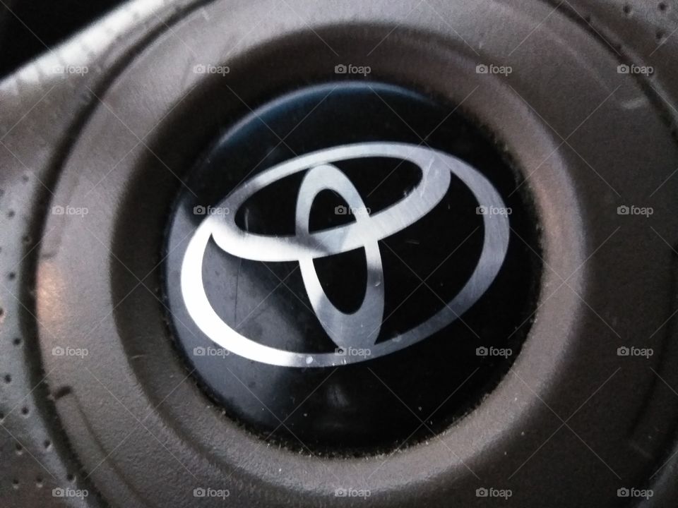 the emblem on the steering wheel of a Toyota