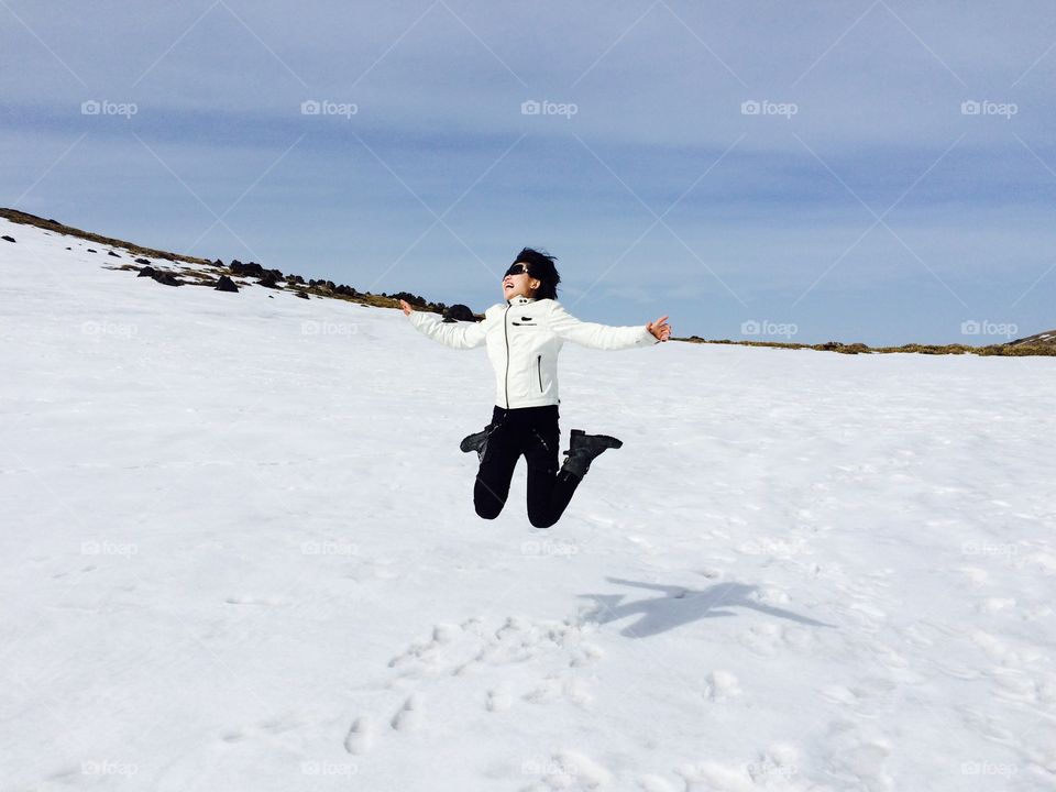 Jump on top of snow mountain . Korean Jeju island 