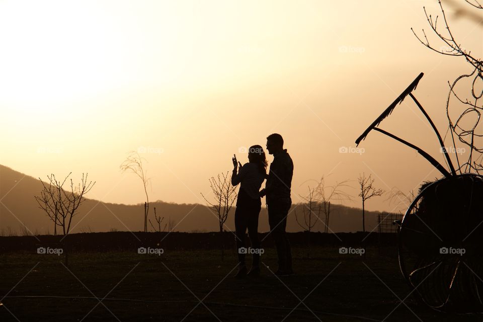 Young loving couple shoot sunset 