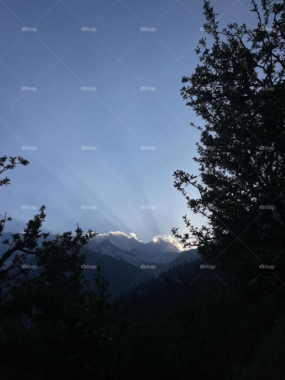 Sunset in mountain through the field 