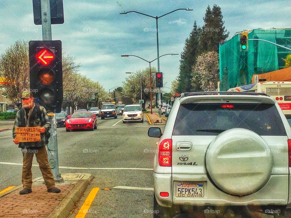 Homeless person begging on street corner