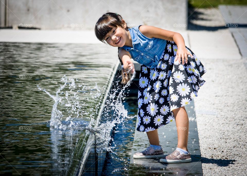 Happy girl is playing with water