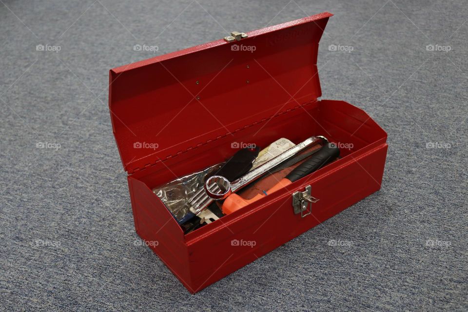 Photo of a red tool box containing tools for workers