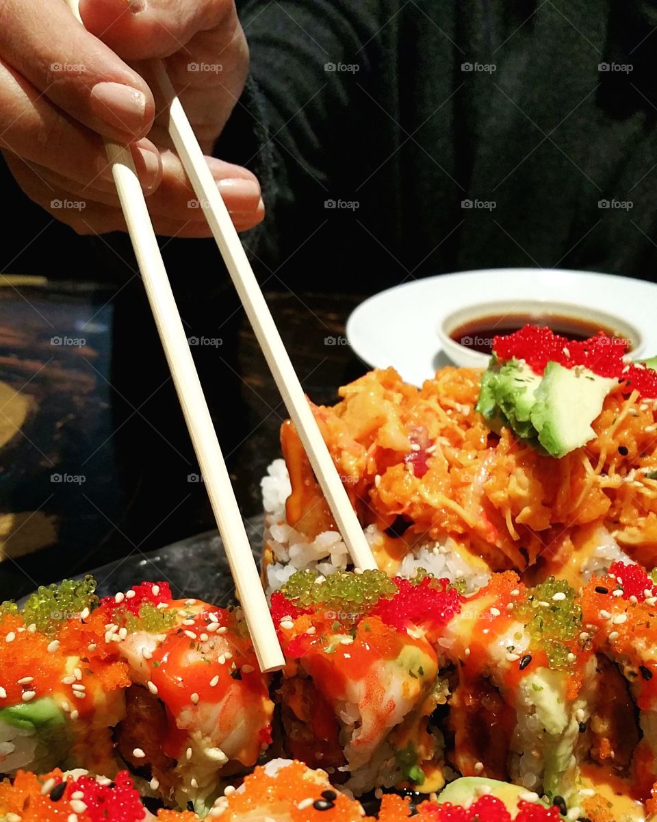 Close-up of a person eating delicious sushi