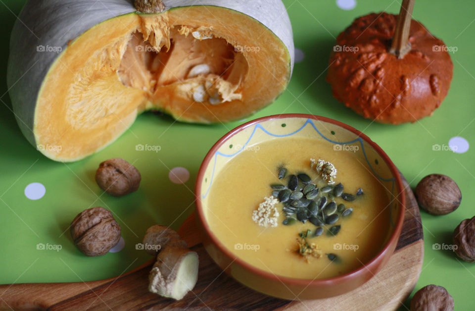 Home made pumpkin soup with sedds, walnuts and ginger