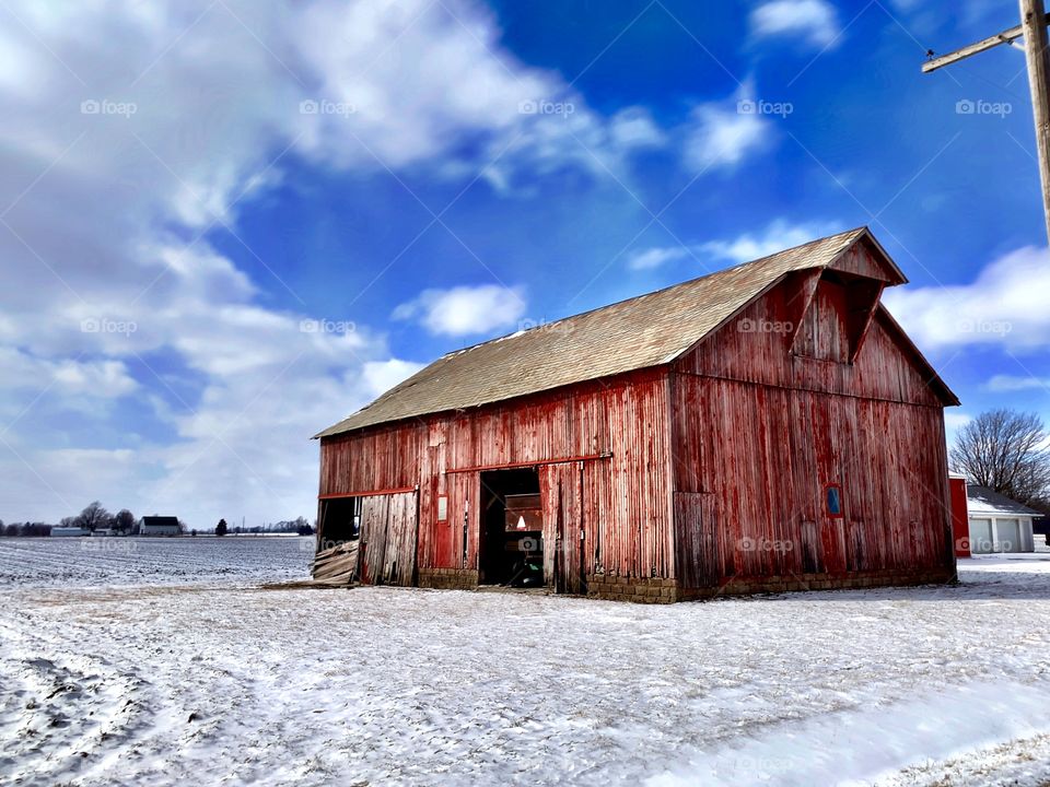 Beautiful view of an old red barn on a winter day in Indiana 