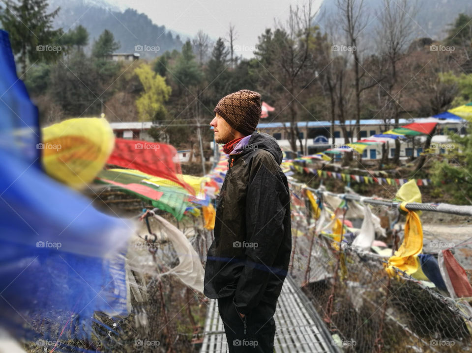 Portrait of man against multicolored flags