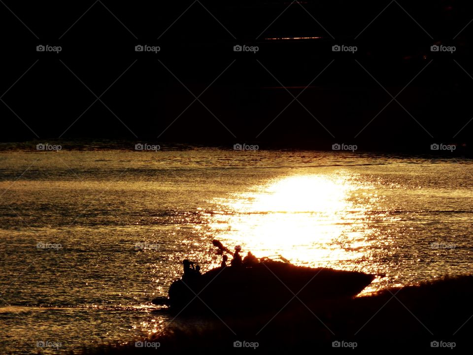 Boat on the lake at sunset 